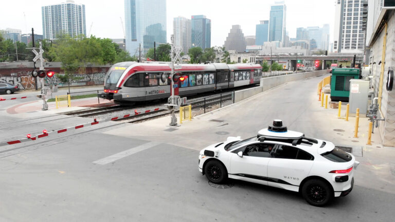A Waymo robotaxi waiting at a railroad crossing in Austin, Texas.