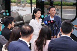 Acting Minister Siow and SMS Sun addressing the media in front of WeRide's Robobus.