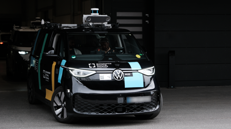 A Bosch and Cariad test vehicle drives out of a dark parking garage