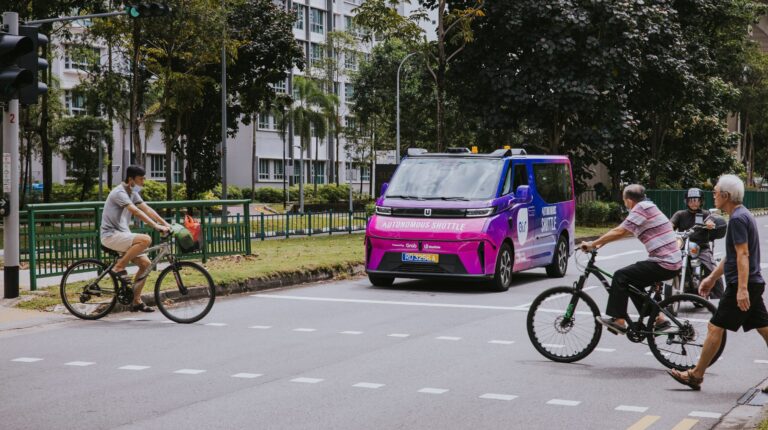 Singapore’s Punggol to host expanded autonomous shuttle tests by WeRide and Grab An Ai.R AV – a WeRide GXR – on a test run in Punggol, Singapore. The vehicle is at an intersection with bicycles and pedestrians crossing the road in front of it