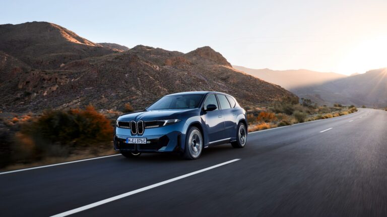 INTERVIEW: Qualcomm Europe’s Enrico Salvatori on the Snapdragon Ride Pilot AD system BMW ix3 drives along a quiet rural road, with the road surface and foreground blurred, illustrating speed of movement.