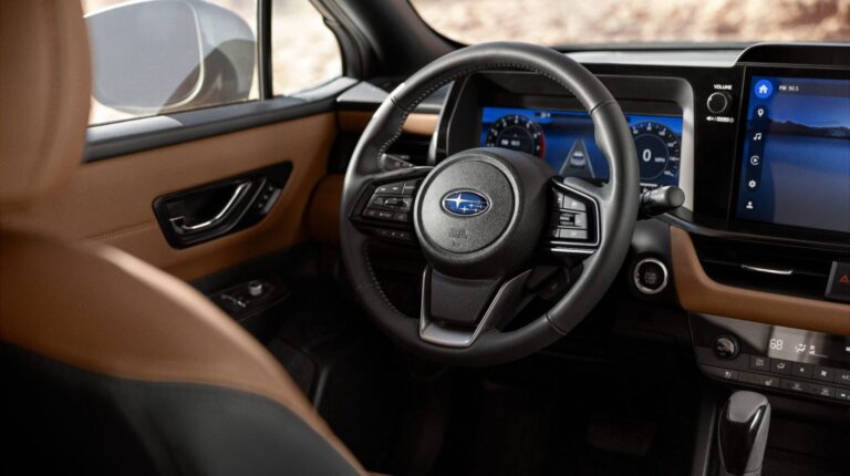 The steering wheel and dashboard of a Subaru Outback Touring vehicle enabled with the Highway Hands-Free Assist system.