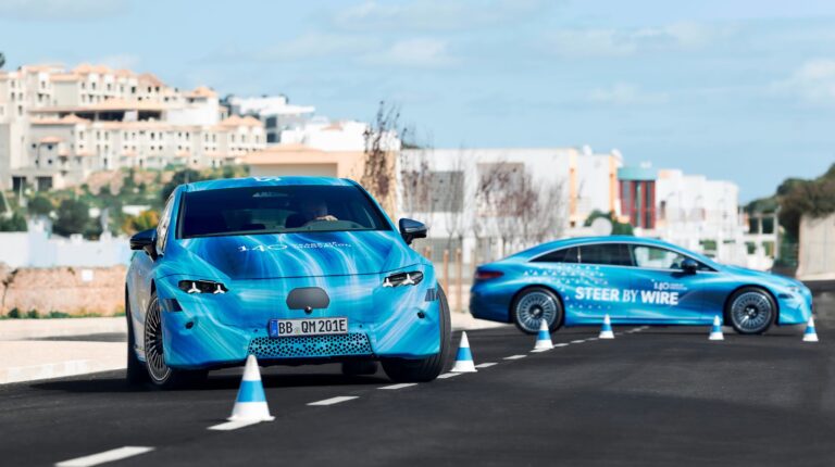 A Mercedes‑Benz EQS in blue and turquoise color scheme undergoing testing on a test track.