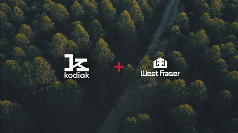 Kodiak AI and West Fraser Timber logos on an image of Canadian forest.
