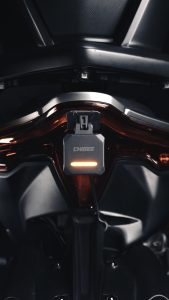 The SR-1 module installed on the bike, warning light active.