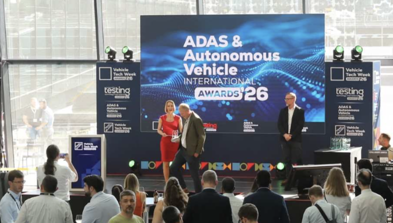 A winner collects their award on the stage at the ADAS & Autonomous Vehicle International Awards 2026