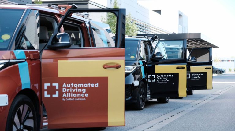 Automated Driving Alliance develops scalable AI-based software stack for Level 2 ADAS A row of parked cars with 'Automated Driving Alliance' branding on the door.