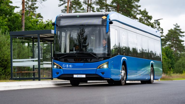 ZF presents City Bus Assist to enhance bus stop approach safety A blue bus pulls up at a bus stop on a quiet street.