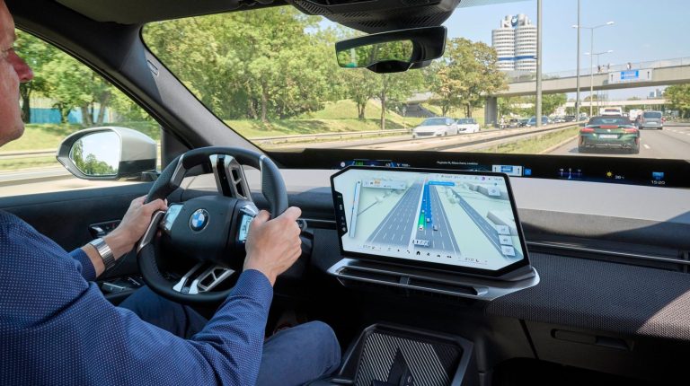 BMW’s 3D Maps combines navigation and driver assistance in a single 3D view Dash of a BMW vehicle with BMW Maps displayed on the center console.