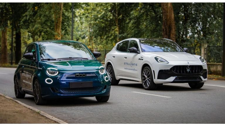 Fiat 500e and Maserati Grecale with Stellantis written down their sides drive along a quiet rural road.