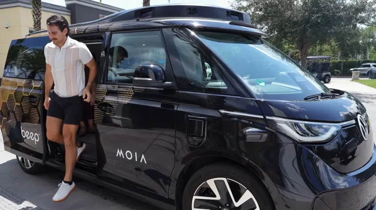 MOIA America welcomes its first riders in autonomous ID Buzz vehicles with Beep A black Volkswagen ID Buzz vehicle with MOIA written down the side.